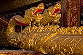 Wat Xieng Thong temple in Luang Prabang, Laos. The wooden pipes in the shape of a naga used during Lao New Year to pour water on a Buddha image. 